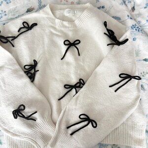 White sweater with 3D black bows